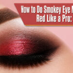 A close-up of a model's eye with red smokey eye makeup.