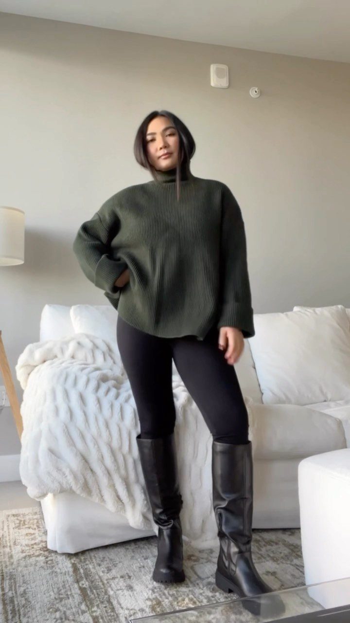 15 Long Boots Outfit Ideas for Cold Months Ahead 13 Woman wearing an oversized green sweater, black leggings, and tall black leather boots.