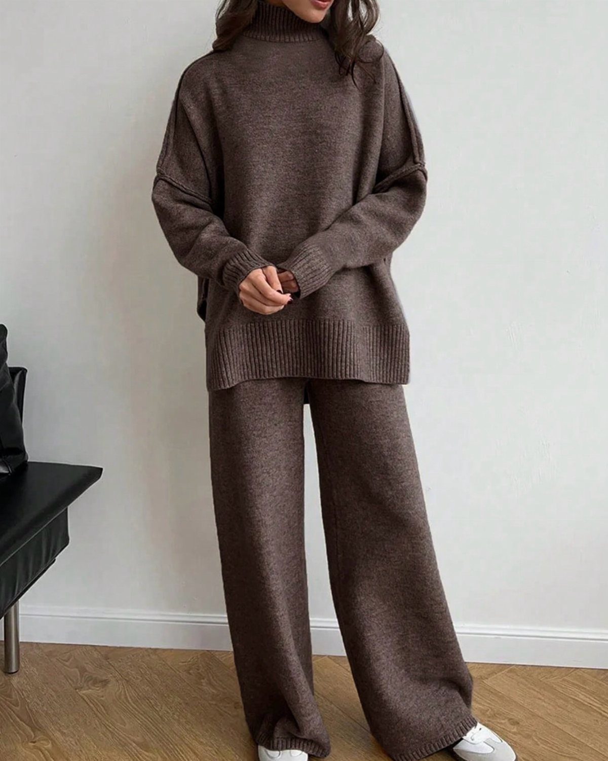 10 Winter Sweater Outfits: From Fair Isle to Full-On Neutrals 8 A person wearing a matching brown knit turtleneck sweater and wide-leg trousers with white sneakers.
