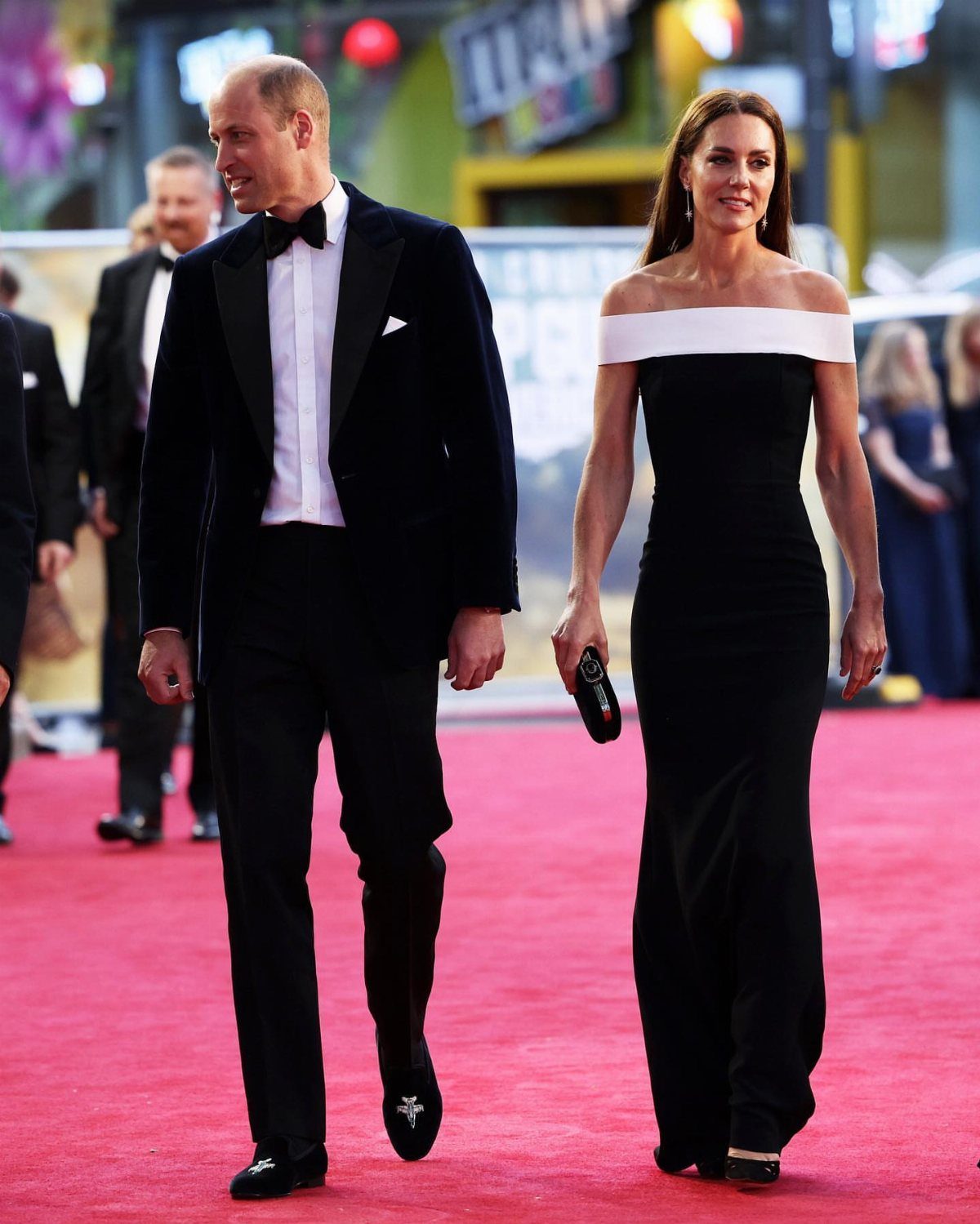 Princess Kate Outfits: 9 Style Templates to Borrow 6 Kate Middleton in a black off-the-shoulder gown walking on a red carpet with Prince William.